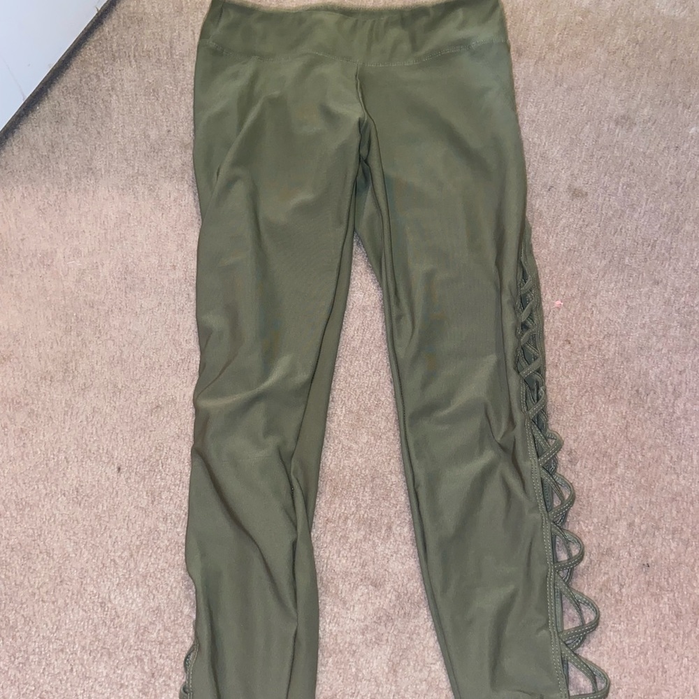 Olive green size small leggings with a cross cross pattern on sides of legs